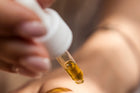 Collagen serum being applied by a dropper