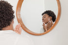 Woman applying non-comedogenic skincare to her face