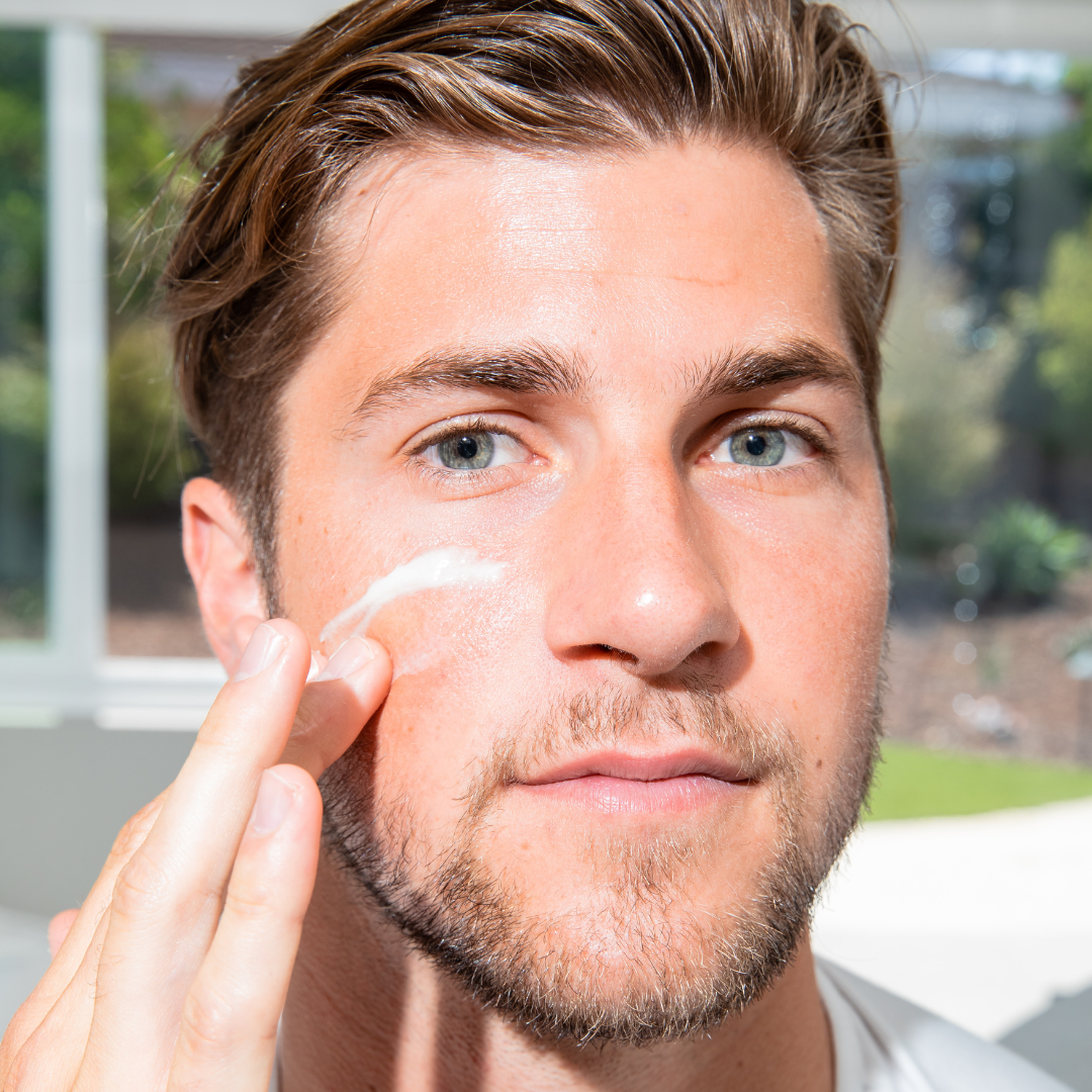 a man applying clearstem product on his face.